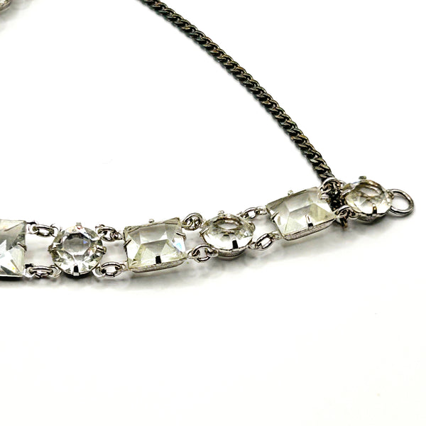 Vintage Art Deco style clear rhinestone geometric bracelet with alternating round and square-cut crystal links in a silver-tone setting on a plain white background