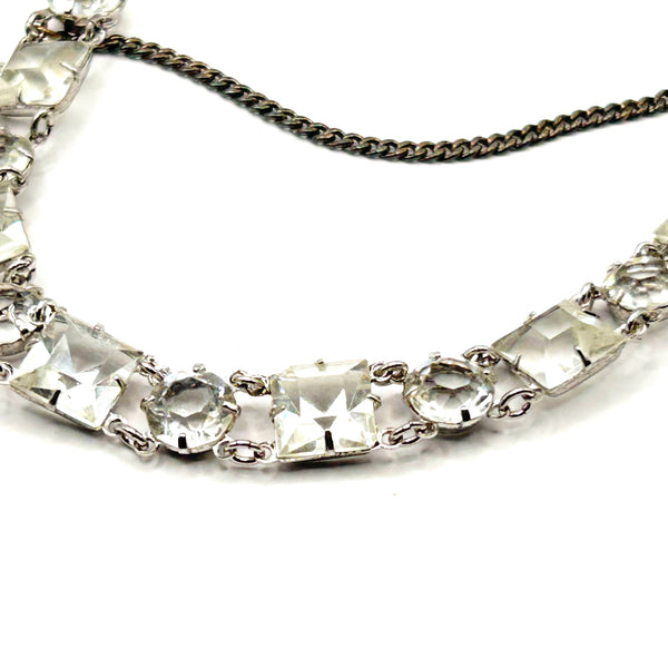 Vintage Art Deco style clear rhinestone geometric bracelet with alternating round and square-cut crystal links in a silver-tone setting on a plain white background