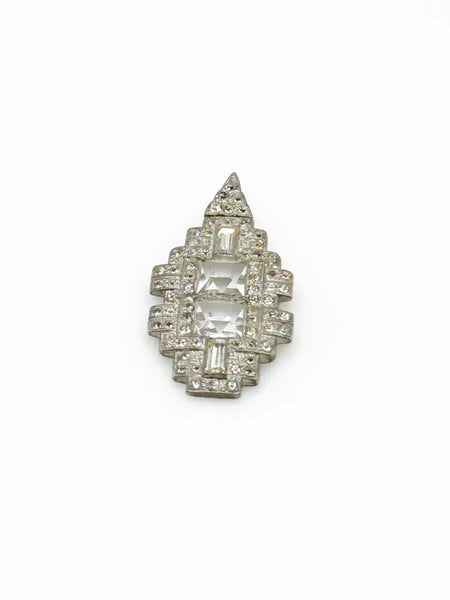 You'll draw attention and compliments with this striking art deco pendant. Its elongated diamond rectangle shape is adorned with dazzling crystals and two sparkling square stones at the center. 