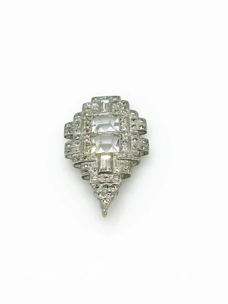 You'll draw attention and compliments with this striking art deco pendant. Its elongated diamond rectangle shape is adorned with dazzling crystals and two sparkling square stones at the center. 
