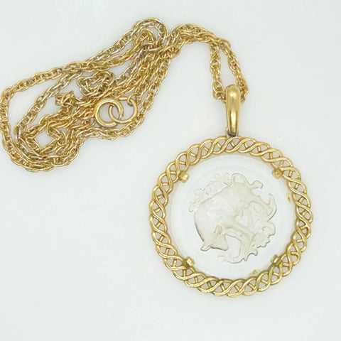 Experience the timeless style and celestial charm of the Trifari zodiac collection with our stunning Taurus pendant. Crafted with intricate details and high-quality materials, this clear glass pendant features a beautifully carved bull design bordered by a lustrous gold tone metal ribbon.