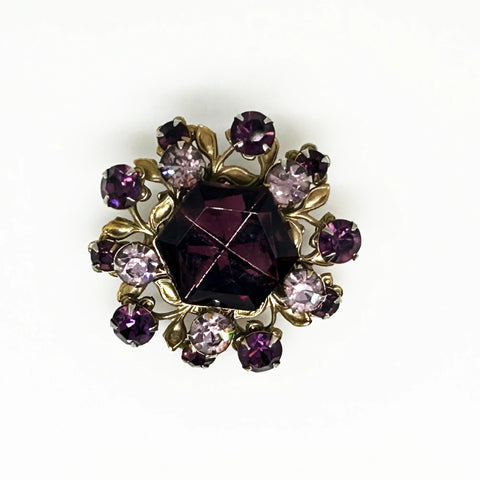 This dazzling brooch features a large octagonal purple stone at its center, surrounded by sparkling lavender and purple round stones. Its two-tiered design highlights the bezel-set centerpiece, making it truly eye-catching. With intricate details that showcase exceptional Czech craftsmanship,