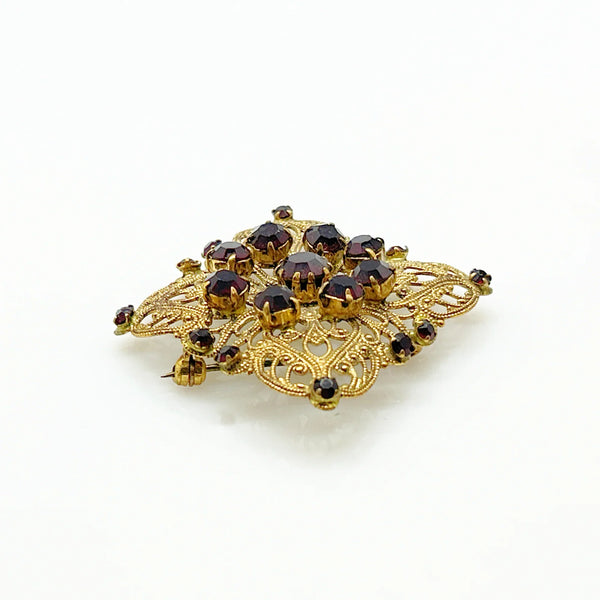 Intricate Vintage Gold Tone Brooch with Ruby Red Stones - Add timeless charm with this ornate brooch featuring deep ruby red stones. Perfect statement piece. Shop now!