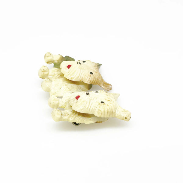 This stunning vintage brooch features a pair of West Highland White Terriers with tilting heads, perfectly capturing the playful nature of these beloved dogs. With exquisite fur texture, piercing black eyes, and adorable red tongues, this brooch is a true testament to the beauty of terriers. Measuring just under 1 1/2" wide and in excellent condition, it is a must-have for any dog lover's jewelry collection.