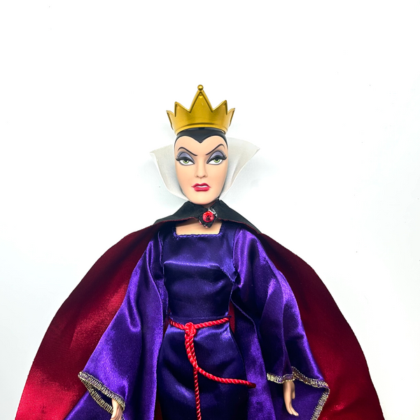 A vintage-style Evil Queen doll with a gold crown, purple gown, and red cape, photographed against a plain white background.