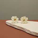 These earrings are blooming with style! Featuring gorgeous magnolia blooms with a golden center, each earring measures just under 1", making them the perfect accessory for any occasion. They have screw back closures and the earrings are in excellent vintage condition