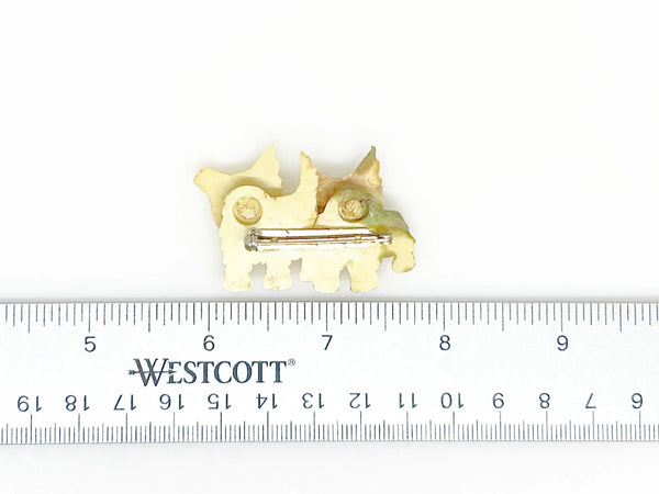 This stunning vintage brooch features a pair of West Highland White Terriers with tilting heads, perfectly capturing the playful nature of these beloved dogs. With exquisite fur texture, piercing black eyes, and adorable red tongues, this brooch is a true testament to the beauty of terriers. Measuring just under 1 1/2" wide and in excellent condition, it is a must-have for any dog lover's jewelry collection.