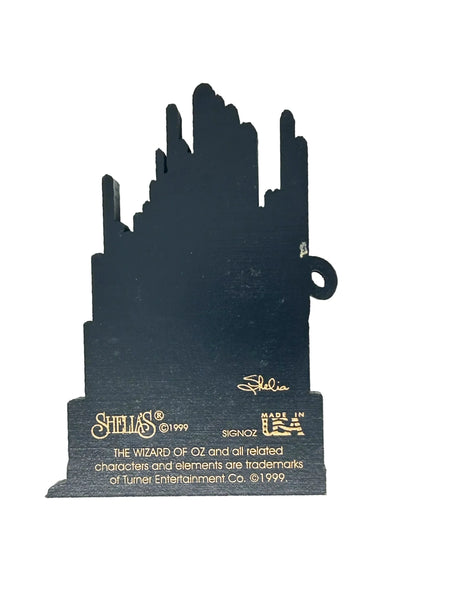 Bring a touch of classic Hollywood magic to your collection with this charming wooden Emerald City shelf sitter from Sheila's Collectibles. Crafted in the 1990s, this iconic piece captures the whimsical green spires of Oz in meticulous detail, complete with "The Wizard of Oz" branding.
