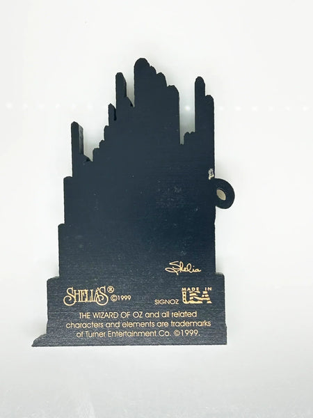 Bring a touch of classic Hollywood magic to your collection with this charming wooden Emerald City shelf sitter from Sheila's Collectibles. Crafted in the 1990s, this iconic piece captures the whimsical green spires of Oz in meticulous detail, complete with "The Wizard of Oz" branding.