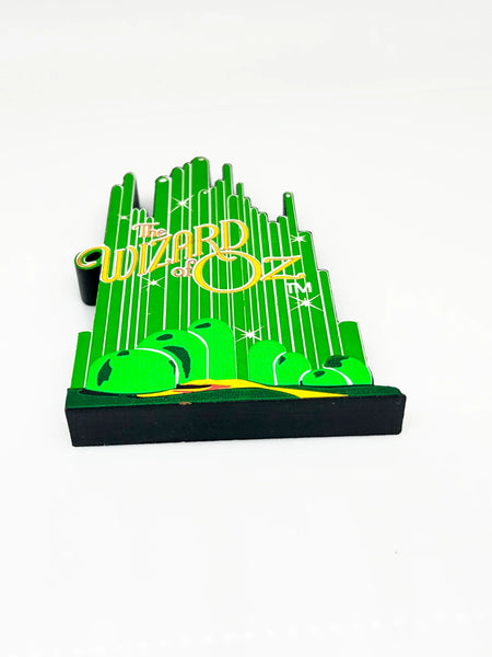 Bring a touch of classic Hollywood magic to your collection with this charming wooden Emerald City shelf sitter from Sheila's Collectibles. Crafted in the 1990s, this iconic piece captures the whimsical green spires of Oz in meticulous detail, complete with "The Wizard of Oz" branding.