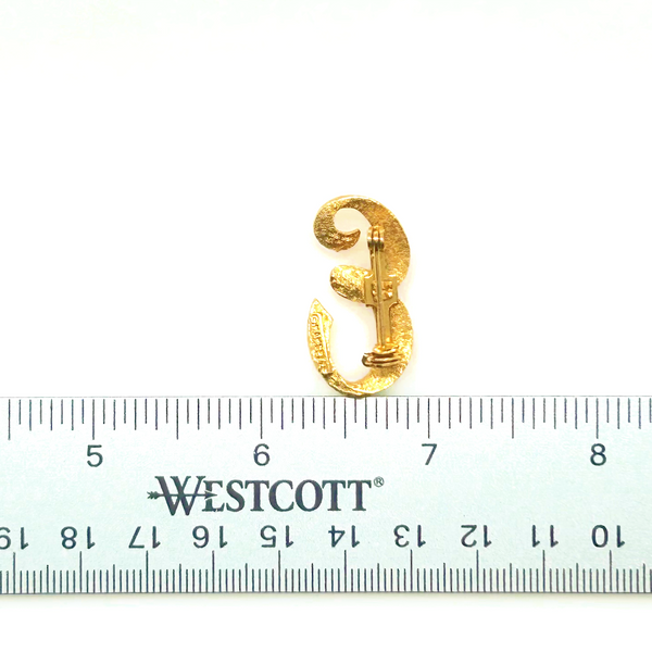 A small, vintage gold-tone initial "E" cursive monogram brooch pin, featuring a dual-textured finish with brushed matte styling and diamond-cut highlights on a plain white background