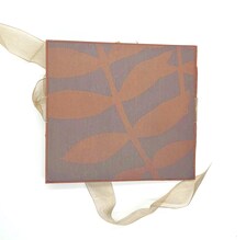 Handmade autumn mini scrapbook album featuring a green and brown plaid pattern, orange paper cover, decorative fall leaves, and a large golden ribbon bow