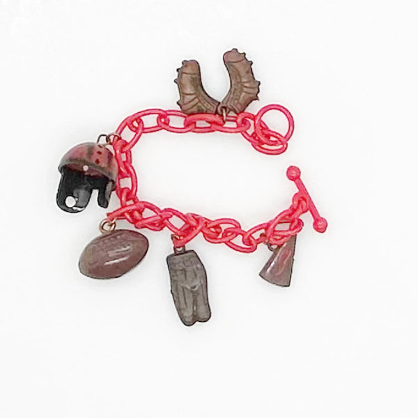 Perfect for sports fans: our Vintage 1930s Plastic Football Charm Bracelet provides unique vintage style and spirited game-day flair. Shop today!
