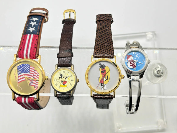 This is a group of four ladies' watches featuring graphic designs - an American flag, Mickey Mouse, a hot dog and a snowman. I don't know if any work, or just require batteries or can be repaired.  The lot would also provide parts for other watches or even craft projects. They are untested.