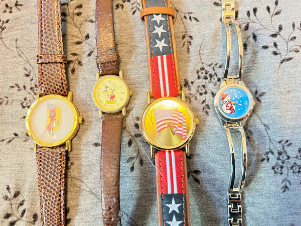 This is a group of four ladies' watches featuring graphic designs - an American flag, Mickey Mouse, a hot dog and a snowman. I don't know if any work, or just require batteries or can be repaired.  The lot would also provide parts for other watches or even craft projects. They are untested.
