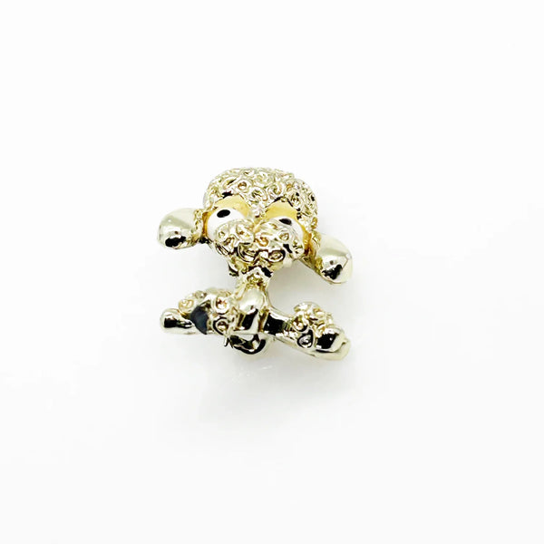 Stand out from the crowd with this adorable Vintage Tiny Gerry's Poodle Brooch with Big Eyes! Its textured gold tone metal and lifelike details make it a unique and charming addition to any outfit.