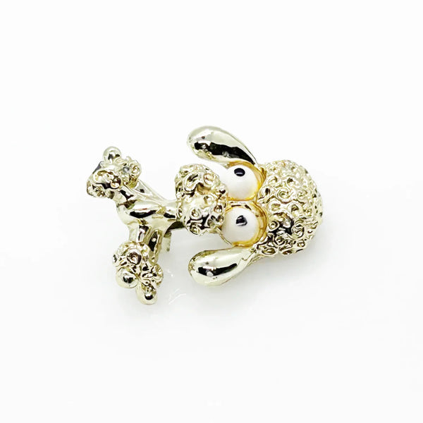Stand out from the crowd with this adorable Vintage Tiny Gerry's Poodle Brooch with Big Eyes! Its textured gold tone metal and lifelike details make it a unique and charming addition to any outfit.