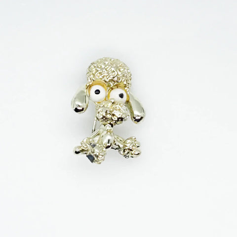 Stand out from the crowd with this adorable Vintage Tiny Gerry's Poodle Brooch with Big Eyes! Its textured gold tone metal and lifelike details make it a unique and charming addition to any outfit.