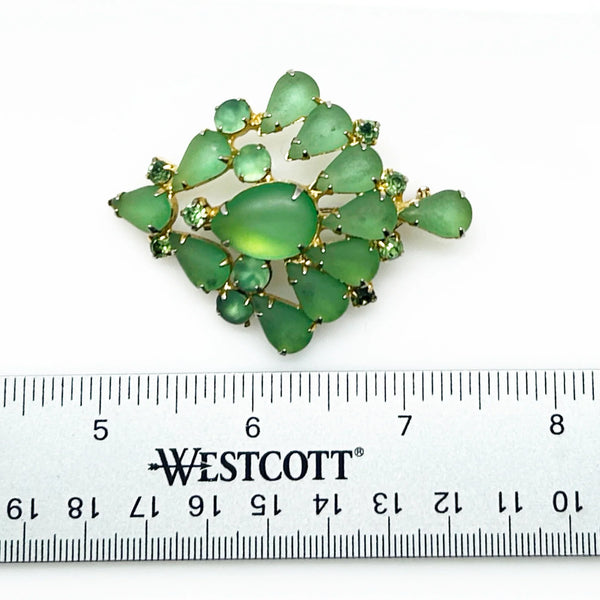  Discover exquisite elegance with this grass green givre glass brooch featuring prong-set stones and a captivating gold-tone design. Shop now!