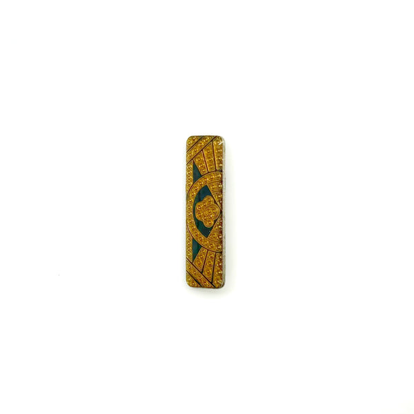 A vintage rectangular Art Deco revival bar brooch in the Pierre Bex style, featuring textured gold-tone metal sunburst rays, dark enamel details, and a central floral cloud medallion against a solid white background