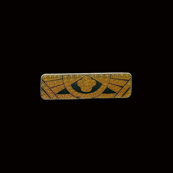 A vintage rectangular Art Deco revival bar brooch in the Pierre Bex style, featuring textured gold-tone metal sunburst rays, dark enamel details, and a central floral cloud medallion against a solid white background
