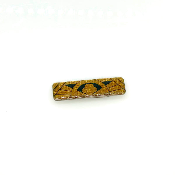 A vintage rectangular Art Deco revival bar brooch in the Pierre Bex style, featuring textured gold-tone metal sunburst rays, dark enamel details, and a central floral cloud medallion against a solid white background