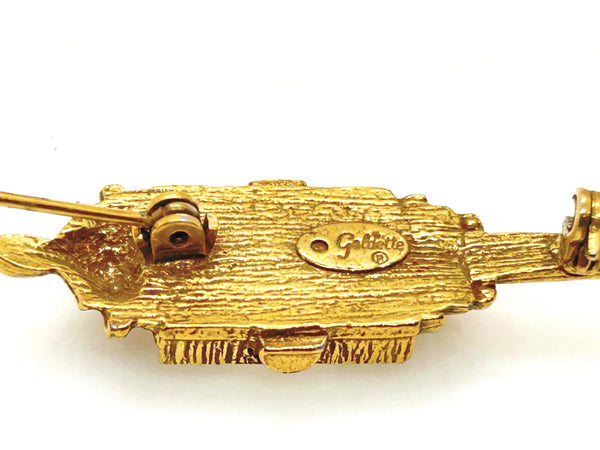 Signed Goldette vintage Victorian Revival gold-tone lantern brooch pin with an emerald-cut clear glass rhinestone