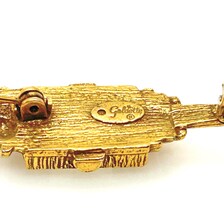 Signed Goldette vintage Victorian Revival gold-tone lantern brooch pin with an emerald-cut clear glass rhinestone