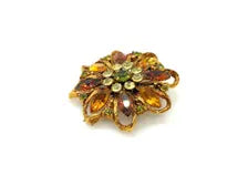 1950s Austrian costume jewelry flower pin with multi-colored faceted crystals and olivine rhinestone center