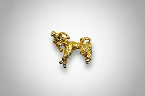 Perfect for vintage jewelry lovers: our Gold Poodle Brooch provides a cute, textured design with green rhinestone eyes that add playful charm. Shop today!