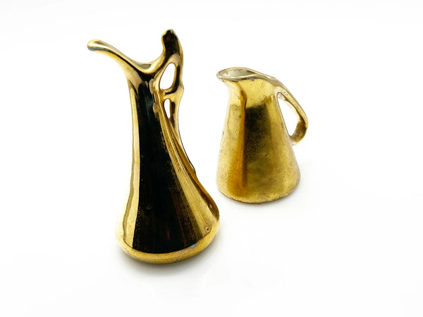 These lovely Victoria HU miniature pitchers are a wonderful addition to any vintage collection. This matched pair, produced in Czechoslovakia during the 1919-1940s era, embodies the refined aesthetic of Art Deco and Hollywood Regency design.
