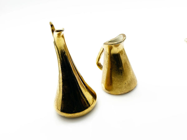 These lovely Victoria HU miniature pitchers are a wonderful addition to any vintage collection. This matched pair, produced in Czechoslovakia during the 1919-1940s era, embodies the refined aesthetic of Art Deco and Hollywood Regency design.