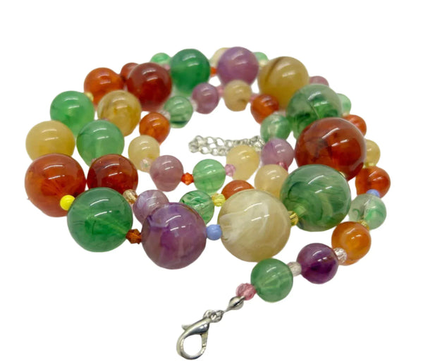 There’s something special about this Graduated Colorful Glass Bead Necklace! It’s stunning to look at and, if your senses are as active as your eyes, your other senses will enjoy it as well.&nbsp; Beads in purple,, jade green and dark red contrast beautifully with one another.