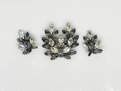 This is a gorgeous set of pin and earrings made with marquise and round shaped rhinestones in gray and clear. They are nestled in a layered, dark metal setting. The stones are standout bright and very sparking, great condition other than some wear on reverse. The earrings are clip on, hinge back.