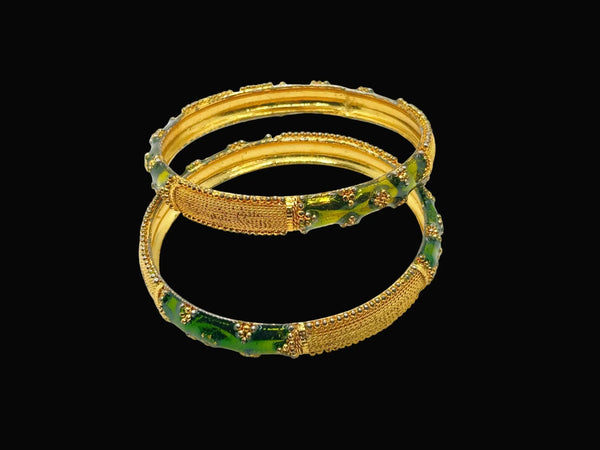A pair of traditional Indian gold-plated bangles showcasing intricate filigree work and vibrant grass green enamel detailing.