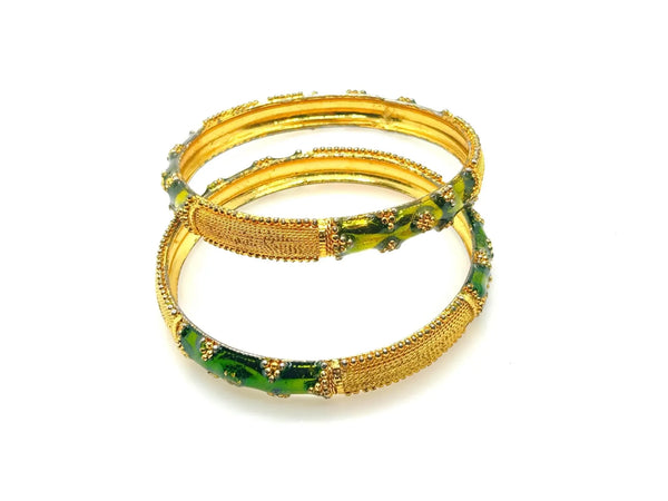 A pair of traditional Indian gold-plated bangles showcasing intricate filigree work and vibrant grass green enamel detailing.