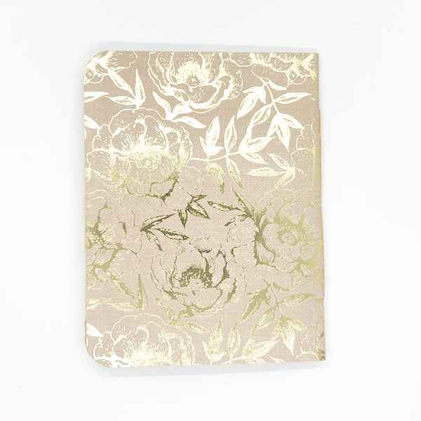This is a beautiful mini scrapbook album with a Victorian air about it. The cover shows a spray of line drawn flowers, in a peach oval with scalloped edges. It rests on a pale brown cover embellished with foil floral decorations. A ribbon of the same hues add the finishing touches.