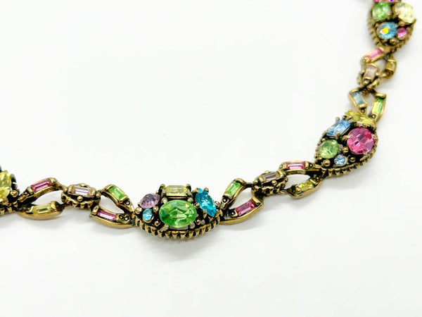 A stunning array of colors and shapes, carefully crafted into a one-of-a-kind piece. With a 4" extender for the perfect fit, this choker is sure to make a statement and add a touch of elegance to any outfit. Don't miss out on this unique and versatile addition to your jewelry collection!
