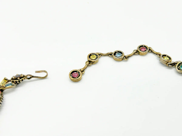 A stunning array of colors and shapes, carefully crafted into a one-of-a-kind piece. With a 4" extender for the perfect fit, this choker is sure to make a statement and add a touch of elegance to any outfit. Don't miss out on this unique and versatile addition to your jewelry collection!