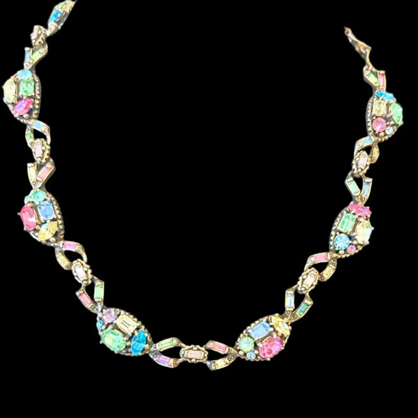 A stunning array of colors and shapes, carefully crafted into a one-of-a-kind piece. With a 4" extender for the perfect fit, this choker is sure to make a statement and add a touch of elegance to any outfit. Don't miss out on this unique and versatile addition to your jewelry collection!
