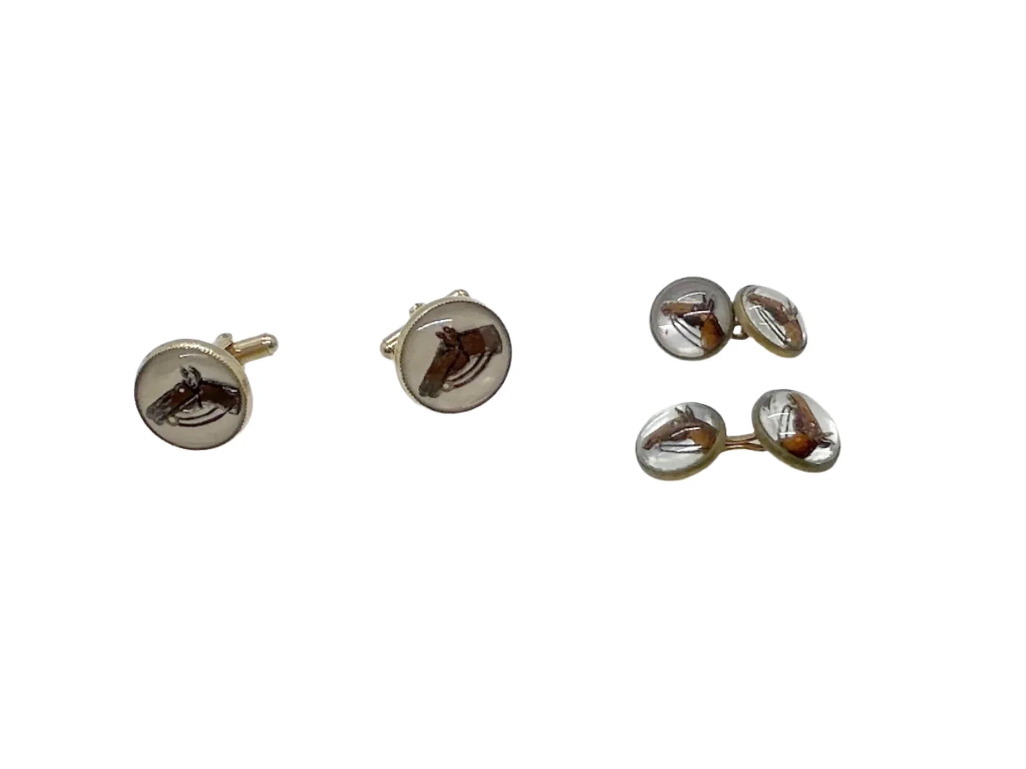 Indulge in timeless sophistication with these exquisite vintage cufflinks featuring an elegant horse design. The larger, 3/4" toggle type pair showcases a majestic brown horse with reins, while the smaller, 1/4" close end bridge style pair adds a touch of opulence with its gold tone metal.