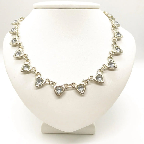 This charming necklace features heart shapes with sparkling round rhinestones at the center. Flip it over to reveal solid hearts with a sleek brushed finish—wear it whichever way suits your mood! Measuring 16" long, it’s secured with an adjustable whimsical flower clasp and a trusty lobster closure for a fun, flirty touch.
