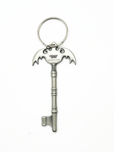 Metal key-shaped bottle opener with a bat design on a white background