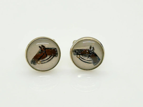Indulge in timeless sophistication with these exquisite vintage cufflinks featuring an elegant horse design. The larger, 3/4" toggle type pair showcases a majestic brown horse with reins, while the smaller, 1/4" close end bridge style pair adds a touch of opulence with its gold tone metal.