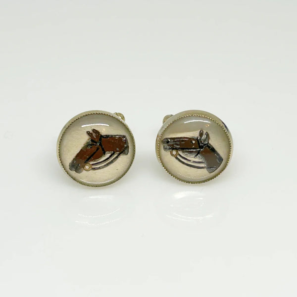 Indulge in timeless sophistication with these exquisite vintage cufflinks featuring an elegant horse design. The larger, 3/4" toggle type pair showcases a majestic brown horse with reins, while the smaller, 1/4" close end bridge style pair adds a touch of opulence with its gold tone metal.