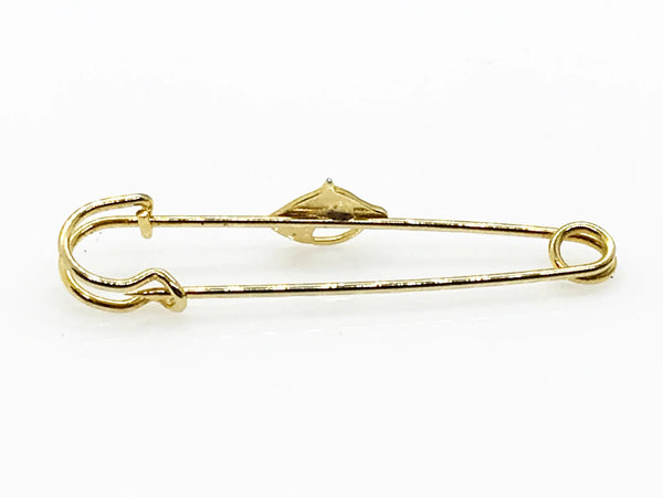 This exquisite gold-tone horse head brooch is perfect for adorning blouses, kilts, or skirts with equestrian elegance. This sophisticated accessory, measuring .25" wide by 2.5" long, presents in impeccable near-mint condition