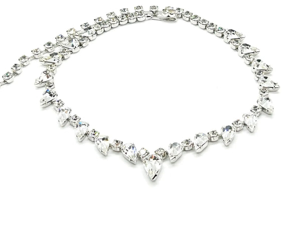 Discover the magic of this stunning vintage Superb Kramer Rhinestone Necklace, where icy brilliance meets timeless elegance. Adorned with crystal-clear marquise and pear-cut stones nestled in gleaming rhodium-plated silver-tone metal, this 14.5" beauty practically dances with light.