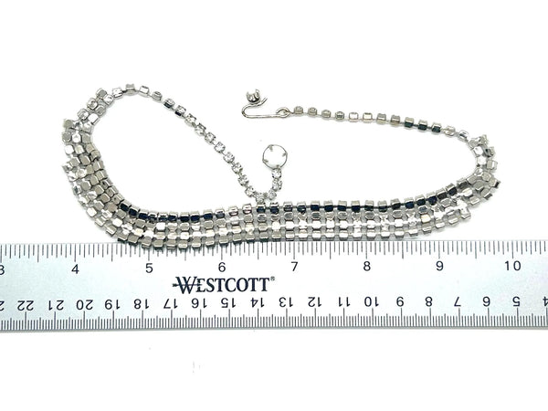 This dazzling choker brings serious sparkle to any outfit! Featuring creamy white milk glass cabochons paired with crystal-clear rhinestones, all nestled in a silvery mesh setting, it's pure vintage, subtle, glamour. 