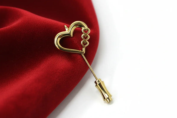 This sweet retro heart stick pin is so charming! It has an openwork design with three smaller hearts along the side.