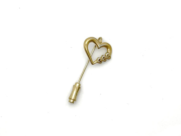 This sweet retro heart stick pin is so charming! It has an openwork design with three smaller hearts along the side. These pins were super popular in the 70s and 80s, perfect for sweaters, blazers, or even scarves. It's 1.5" long and in great shape!